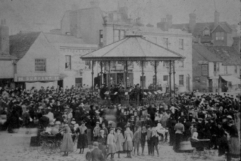 A Victorian crowd around the bandstand in the Carfax