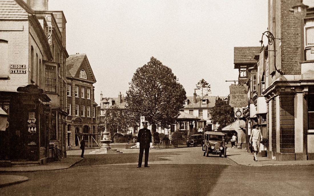 A policeman on point duty in the Carfax, with an early motor car